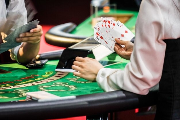 Croupier dealing cards at physical blackjack table